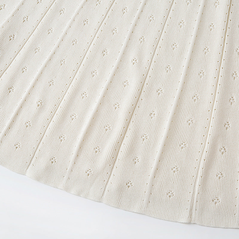 White dress with round neckline, sleeveless, pleated skirt with bead embroidery, high-quality knit fabric