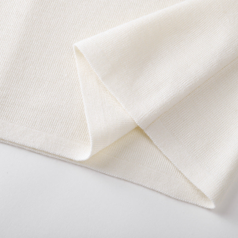 Elegant, high-quality sweater with a round neckline, slim fit, long sleeves, 100% wool, and rhinestone embellishments