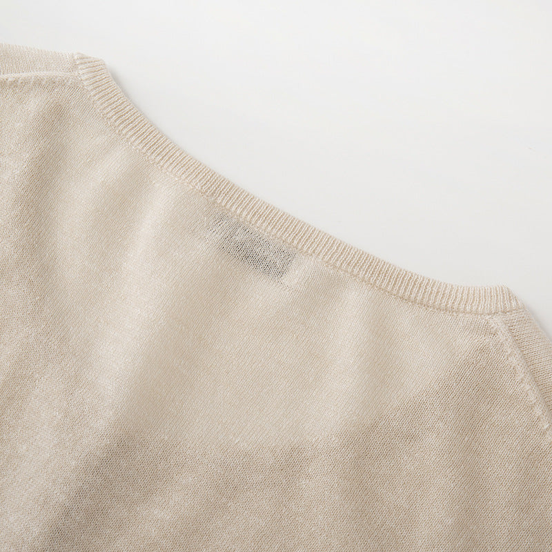 Lightweight knit jacket with a round neckline, long sleeves, and simple buttons, made from a high-quality wool and linen blend