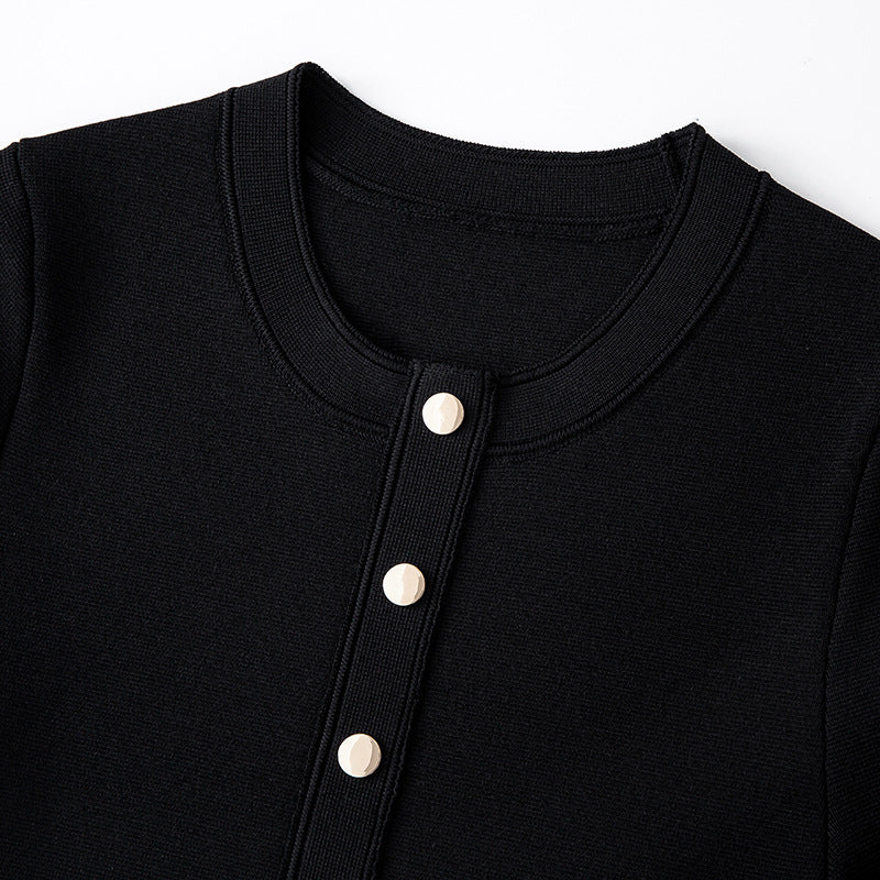 Elegant black and white French-style dress with contrasting round neckline, short sleeves, buttons, and high-quality pleats