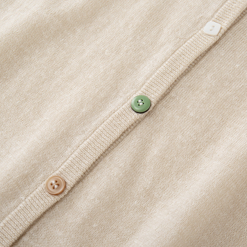 Lightweight knit jacket with a round neckline, long sleeves, and simple buttons, made from a high-quality wool and linen blend