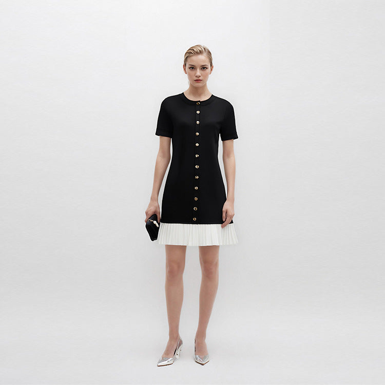 Elegant black and white French-style dress with contrasting round neckline, short sleeves, buttons, and high-quality pleats