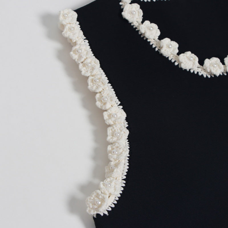 Sophisticated and elegant set featuring a black lace-knit vest with a high-quality, high-waisted, short A-line skirt