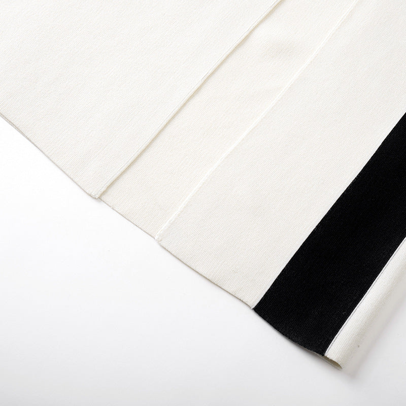 High-quality, elegant strapless, sleeveless knit dress with contrasting black and white patchwork, slimming slit, and mid-length.