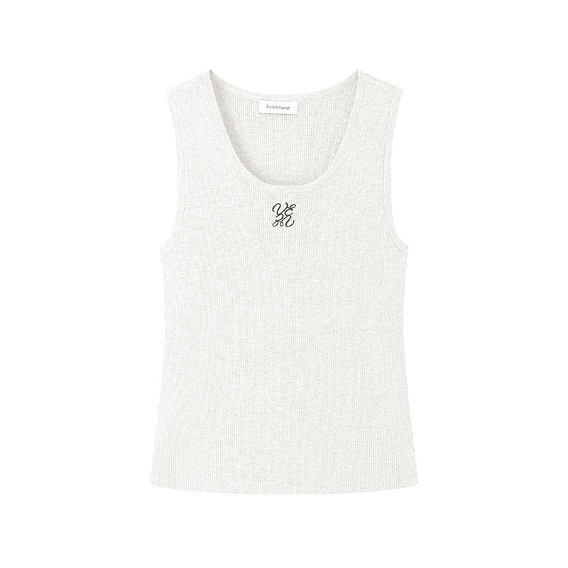 Elegant blouse with a round neckline, sleeveless, and halter neck, made from luxurious embroidered wool knit fabric.