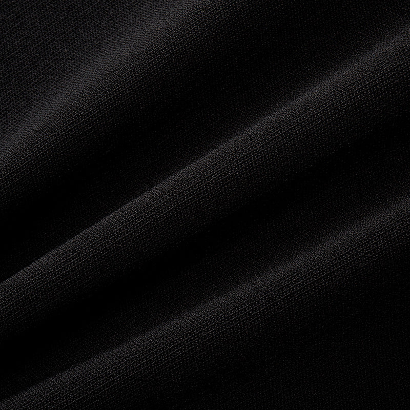 Elegant set consisting of a black sleeveless blouse with a round neckline and studs, paired with a high-waisted skirt with high-quality knit lacing