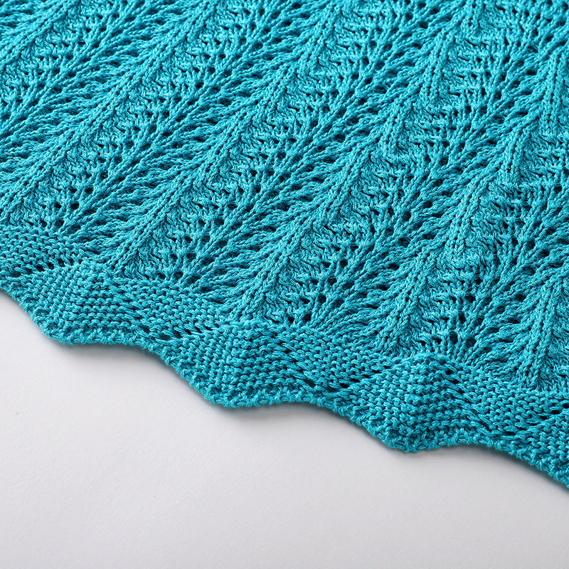 Elegant knit beach dress with blue V-neckline, long sleeves, low waist, and mid-length