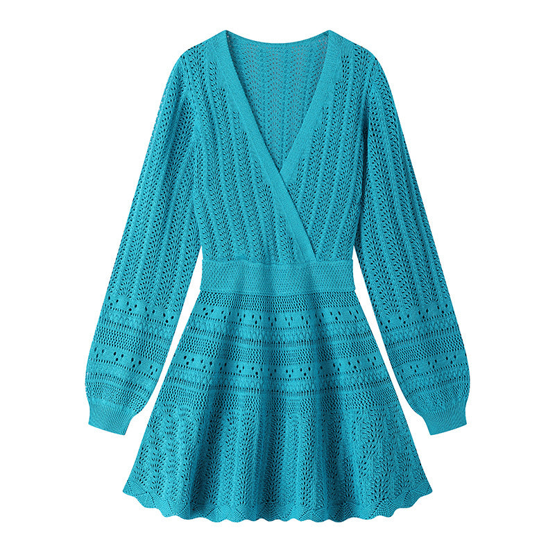 Elegant knit beach dress with blue V-neckline, long sleeves, low waist, and mid-length
