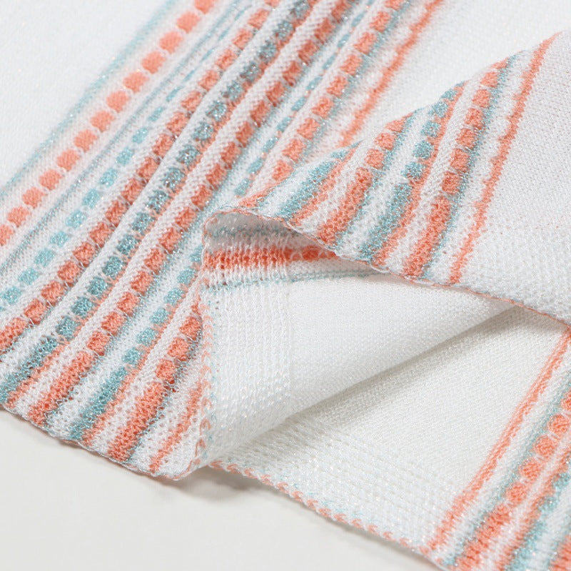 Fitted sleeveless dress with an elegant V-neckline, made from Tencel fabric with high-quality gold and silver stripes