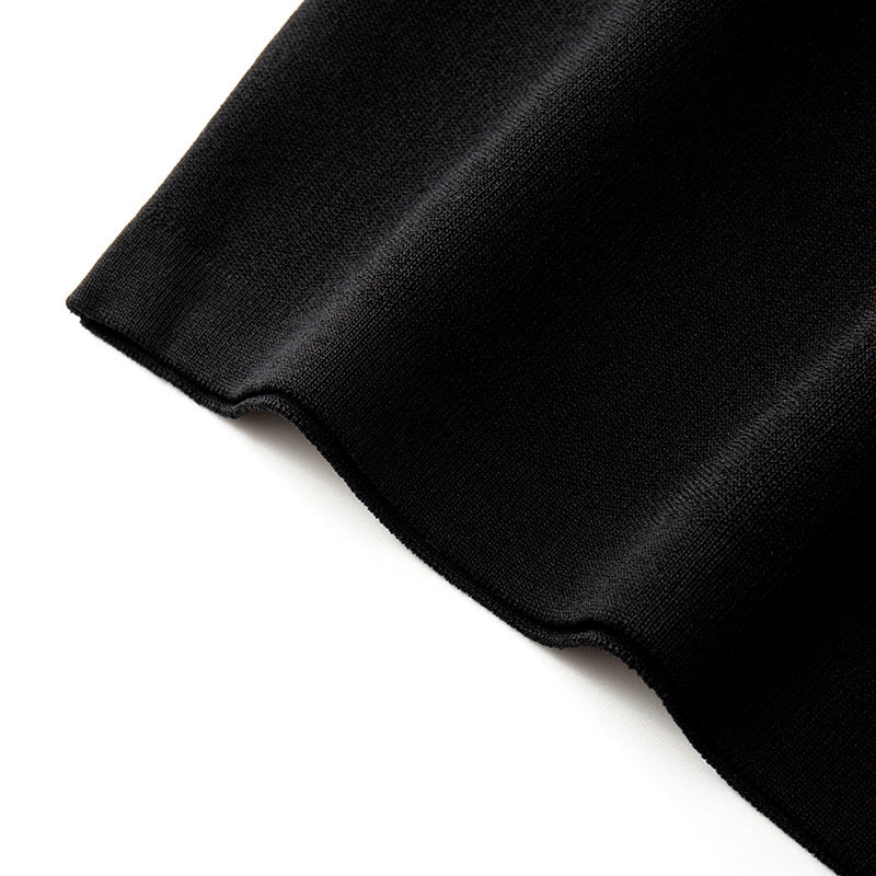 Elegant set consisting of a black sleeveless blouse with a round neckline and studs, paired with a high-waisted skirt with high-quality knit lacing