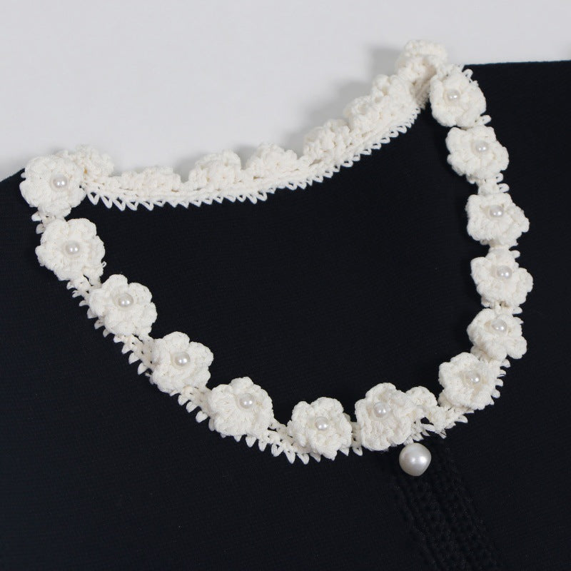 Sophisticated and elegant set featuring a black lace-knit vest with a high-quality, high-waisted, short A-line skirt