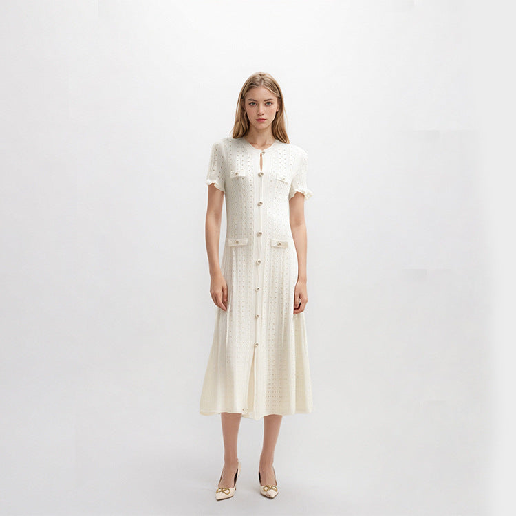 High-quality, elegant French-style dress with a round neckline, short sleeves, simple buttons, longer hem, and lace trim