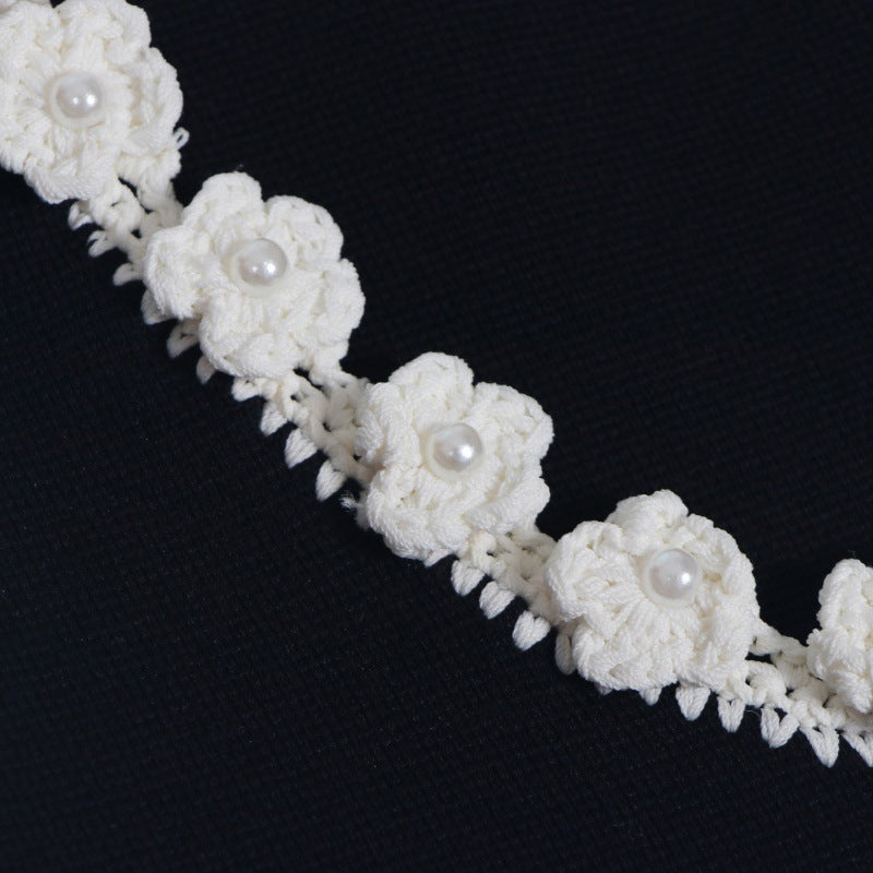 Sophisticated and elegant set featuring a black lace-knit vest with a high-quality, high-waisted, short A-line skirt