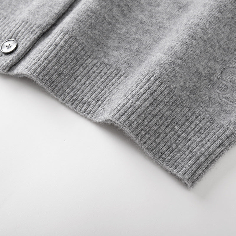 Stylish gray sweater with round neck, long sleeves, front buttons, and 100% high-quality wool