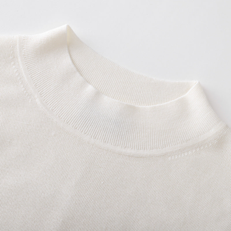 Elegant, high-quality sweater with a round neckline, slim fit, long sleeves, 100% wool, and rhinestone embellishments